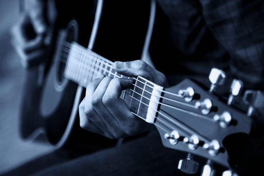 Close up photo of guitar player. Black and white photo
