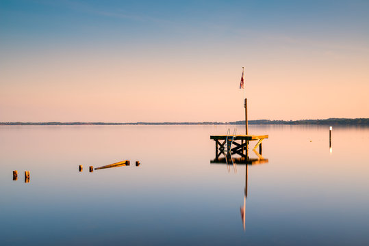 View of diving platform in lake during sunset