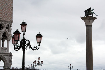 San Marco square in Venice Italy in rainy day. Column with lion. Palace
