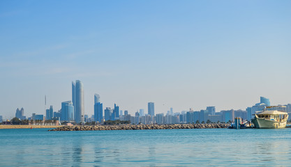 Fototapeta premium Abu Dhabi city skyline along Corniche beach taken from a boat