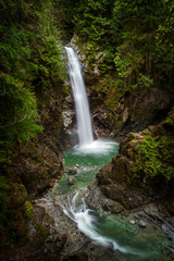 Obraz premium Cascade Falls Regional Park. Located Northeast of Mission, British Columbia, Cascade Falls is a scenic waterfall that can be viewed from a suspension bridge that crosses the river.