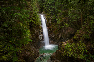Fototapeta na wymiar Cascade Falls Regional Park. Located Northeast of Mission, British Columbia, Cascade Falls is a scenic waterfall that can be viewed from a suspension bridge that crosses the river.