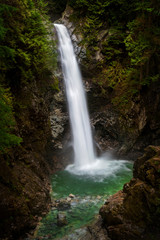 Fototapeta na wymiar Cascade Falls Regional Park. Located Northeast of Mission, British Columbia, Cascade Falls is a scenic waterfall that can be viewed from a suspension bridge that crosses the river.
