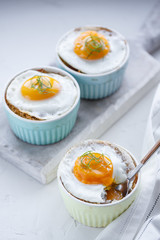 Breakfast with baked eggs with potato and mushrooms, close view