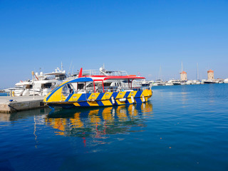 Fototapeta na wymiar The sights on Mandraki Harbour on the island of Rhodes a popular tourist attraction