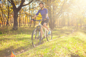 Naklejka premium Biking in the forest.