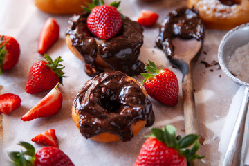 Homemade donuts with powdered sugar and strawberry 