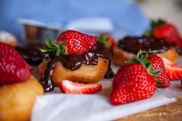 Homemade donuts with powdered sugar and strawberry 