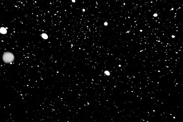 falling snow on a black background, snowfall at night, white spots on a black background
