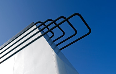 Seafaring: White funnel of a RoRo vessel in front of the bright blue sky