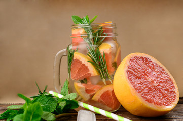  Lemonade with rosemary and grapefruit on a wooden table