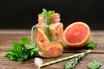  Lemonade with rosemary and grapefruit on a wooden table