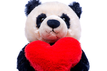 Panda bear stuffed plush toy with red fluffy heart isolated on white background.