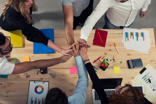 Business people putting their hands together. Concept of integration, teamwork and partnership