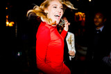 Woman in red dressing dancing at party