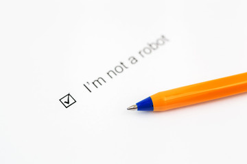 I'm not a robot - checkbox with a check mark on white paper with pen. Checklist concept