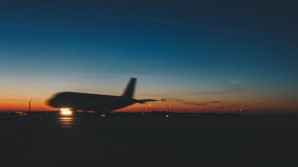 Fototapeta na wymiar Passenger jet plane against beautiful dusky sky