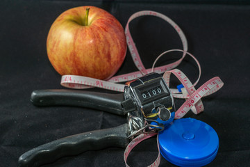 Concept - Getting in Shape. Closeup on Measuring Tape and Apple