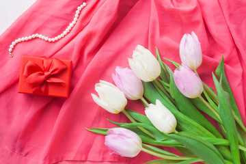 White and purple tulips and a gift in a red box on a white wooden background. Spring. International Women's Day. Valentine's Day. card ,Selective focus.