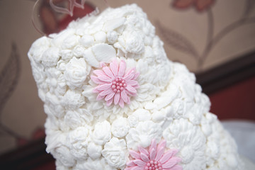 Fototapeta na wymiar traditional wedding cake with white floral icing