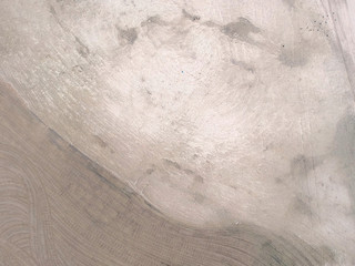 Minimal aerial view of a beautiful yellow gold sand dune beach after cleaning. Background texture of desert sand field from above. Sandy desert top view.