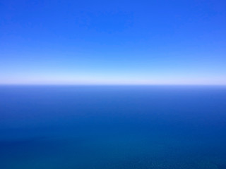 Obraz premium Blue lake water and sky, water scape with horizon and clear deep blue sky. Aerial background.