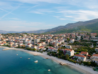Fototapeta na wymiar Scenic aerial bird view at morning coastal village near Split in Croatia, calm and quite tourist vocational hotel seafront under green mountains in Europe. 360 panoramic photography.
