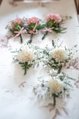 Fototapeta na wymiar white roses buttonhole corsage displayed before the wedding