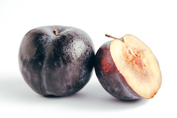 Fresh purple plum isolated on white background
