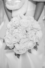 A bride holding her white rose bouquet 