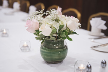 White roses displayed on table at a wedding