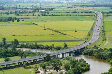 aerial view of highway in green fields