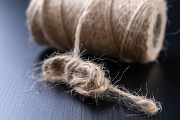 Twine for wrapping packages on the table. Jute string wrapped around the roller.