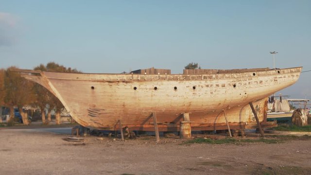 Wide handheld shot of traditional carvel built sailing boat