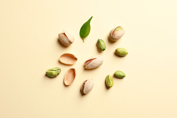 Composition with organic pistachio nuts on color background, flat lay