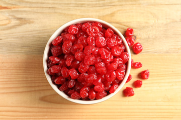 Bowl of sweet cherries on wooden background, top view. Dried fruit as healthy snack