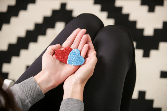 A woman holding red and blue hearts, love and relationships, Valentine day and dating concept