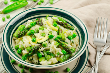 Spring risotto. Risotto with green asparagus, zucchini and pea.  