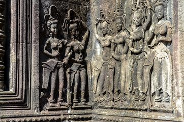 Dancing apsara woman ancient wall carving in Angkor Wat