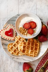 Valentines day breakfast heart shaped waffles and yogurt granola bowl