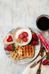 Valentines day breakfast heart shaped waffles and yogurt granola bowl