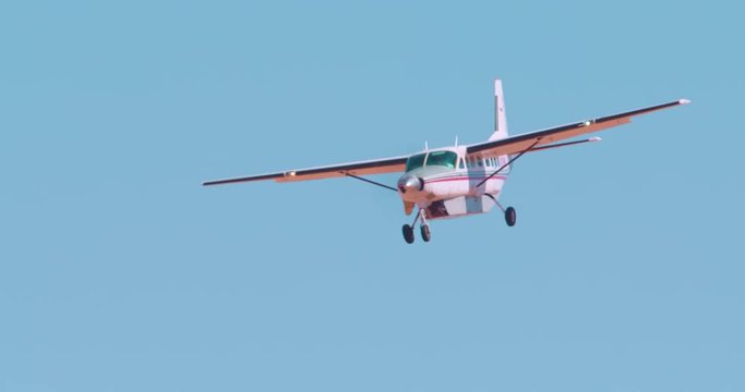 Small sightseeing airplane coming in for landing (no markings)