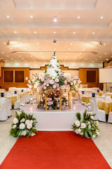 wedding cake with Decorated with flowers and Candlestick at marriage ceremony