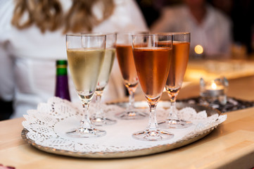Rose and white sparkling vine glasses on a silver tray