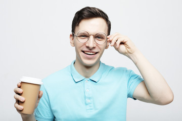 Hipster man standing with takeaway coffee