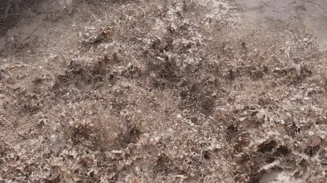 Close-up slow motion rough and choppy muddy river water, 180 fps