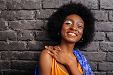 Pretty african american model in a trendy shirt looking cheerful