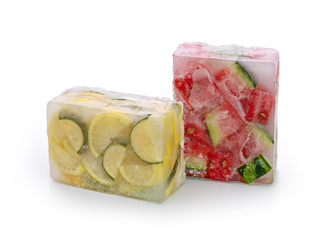 Frozen food concept: red watermelon slices, lemon and lime slices were frozen inside ice cubes.
