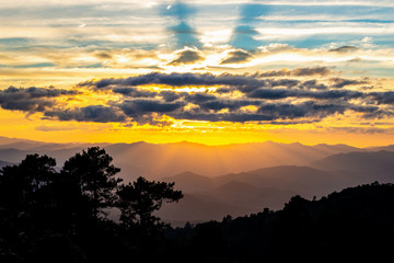 Hazy mountain range with dramatic sunset sky