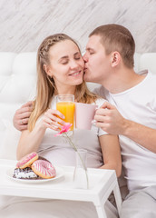 Obraz na płótnie Canvas Romantic happy couple having breakfast at bedroom